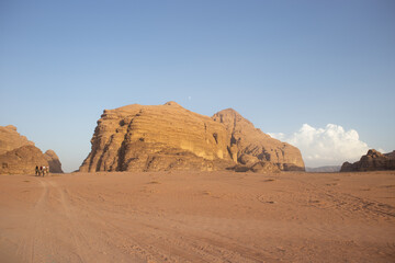 Rocky hillside against a clear blue sky. The sky is very bright, and the sun is shining. The desert is very hot for life, ecology, the heat is very high, there is no vegetation