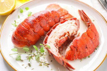 Delicious tails of boiled lobsters served on white table, closeup