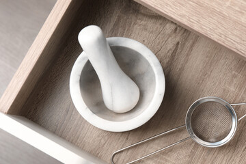 Marble mortar and pestle in drawer indoors, top view