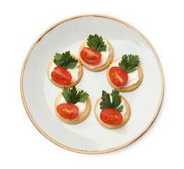 Tasty crackers with cream cheese, tomatoes and parsley isolated on white, top view