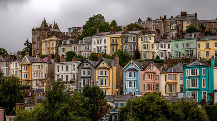 Fototapeta premium View of colorful terraced houses on a hillside under an overcast sky in a residential neighborhood