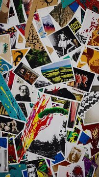 Aerial view of a vibrant collage of photos and art prints, blending nature, portraits, and abstract designs, reminiscent of a dynamic video montage.