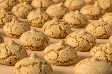 Amaretti cookie background , side view ,flat lay . Neatly stacked rows of cookies on a beige background , high-resolution . 