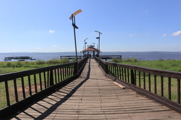 Wooden walkway leading to a pier on Lake Ypacaraí near Areguá, Paraguay
