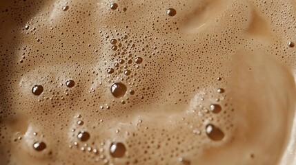 Macro image of cappuccino froth reflective tiny bubbles on light surface gradient