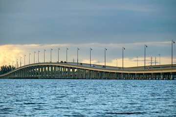 Fototapeta premium Barron Collier Bridge and Gilchrist Bridge in Florida with moving traffic. Transportation infrastructure in Charlotte County connecting Punta Gorda and Port Charlotte over Peace River