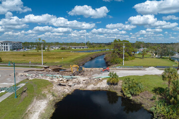 Construction equipment at roadworks site. Reconstruction of damaged road bridge destroyed by river...