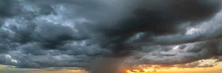 Stormy cumulonimbus clouds before thunderstorm on dark sunset sky. Moving and changing cloudscape...