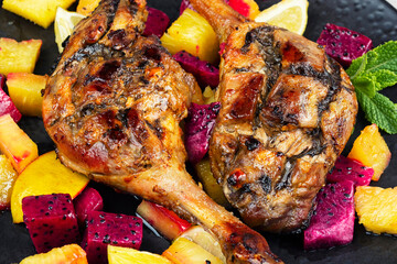 Served with tropical fruits, roast duck leg.