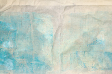 Grunge beige, blue dirty canvas denim fabric stain grain texture background.