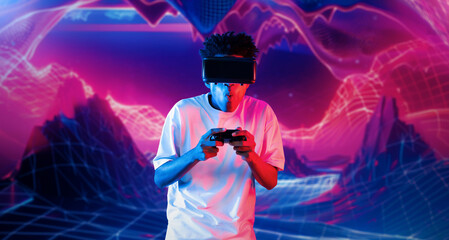 Teenager holding joystick and wearing VR goggles while enjoy playing games at neon abstract...
