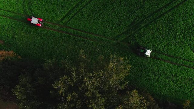 Drone Footage of Tractors Driving and Standing on Farmland &ndash; Aerial View of Agricultural Machinery in Action