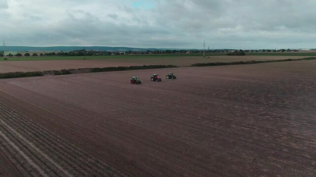 Drone Footage of Tractors Driving and Standing on Farmland &ndash; Aerial View of Agricultural Machinery in Action