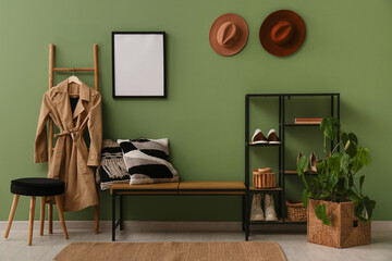 Bench and stand for shoes near green wall in interior of hallway