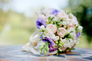 Beautiful Floral Bouquet Featuring Pale Pink Roses and Lilac Accents on Decorative Tile.