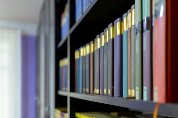 Various types of books on a library shelf
