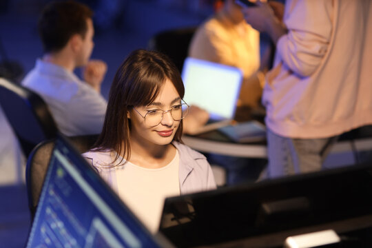 Female programmer working in office at night