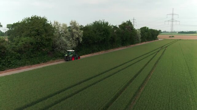 Drone Footage of Tractors Driving and Standing on Farmland &ndash; Aerial View of Agricultural Machinery in Action