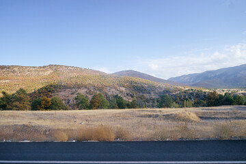 Scenic Valley With Autumn Foliage and Rolling Mountain Hills Under Blue Skies..