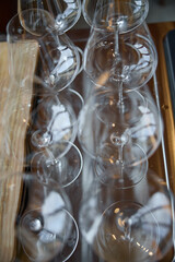Clean wine glasses are on the table of a special wine cabinet, stylish table setting, ice, bottle of sparkling wine, light from window, decoder and degasser