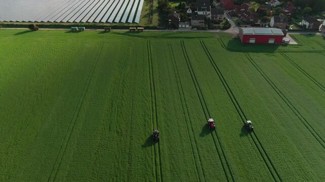 Drone Footage of Tractors Driving and Standing on Farmland &ndash; Aerial View of Agricultural Machinery in Action
