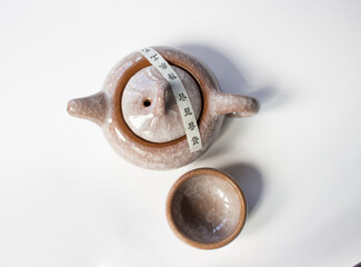 Chinese tea set. brown teapot and 1 teacup with isolated on beautiful white background