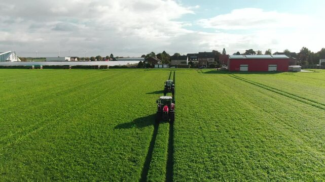 Drone Footage of Tractors Driving and Standing on Farmland &ndash; Aerial View of Agricultural Machinery in Action