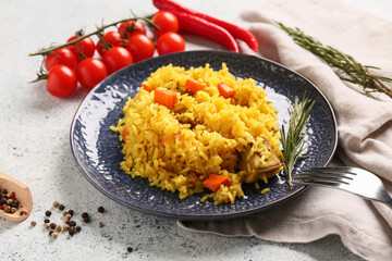 Plate of tasty pilaf with rosemary, chili peppers and cherry tomatoes on white background, closeup