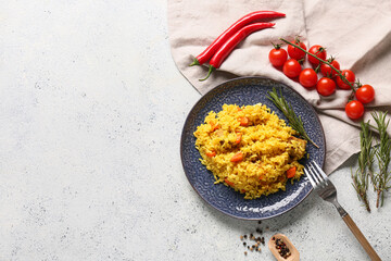 Plate of tasty pilaf with rosemary, chili peppers and cherry tomatoes on white background