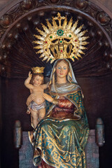 Statue (19th century) of Blessed Virgin Mary holding baby Jesus Christ in her arms.