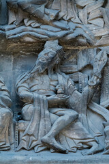 One of the twenty-four Elders of the Apocalypse, holding harps in praise of God, carved on the tympanum of Moissac (12th century).
