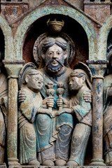 Tympanum of the Last Judgment (12th century). Abraham holding two children in his arms.