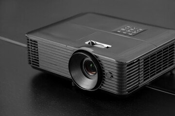 Modern projector on desk in conference hall, closeup