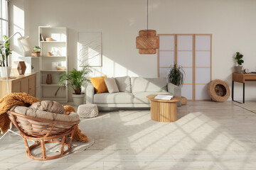 Interior of modern studio apartment with sofa, armchair and workplace