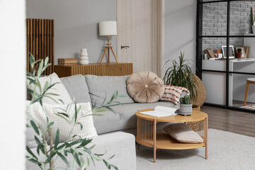 Interior of studio apartment with sofas, table and folding screen