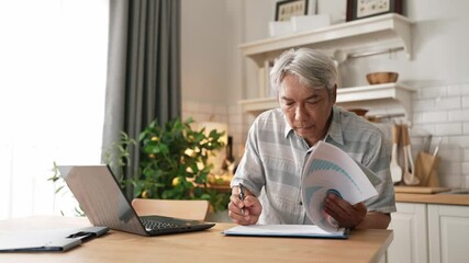 Senior business man with casual cloth looking at financial chart at home while working on laptop and making decision. Manager sitting at home while writing at document and planning strategy. Myrmidon. - Powered by Adobe