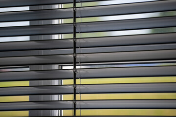 Workshop and office metal horizontal blinds line detail on background.	
