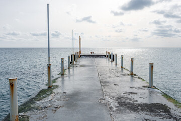 Fototapeta premium Empty concrete pier by the winter sea on a sunny day