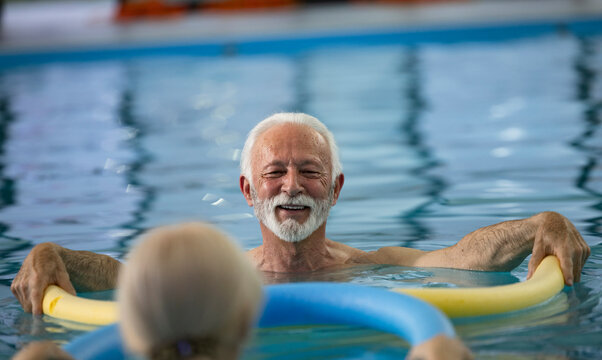 Elderly couple doing exercises in indoor pool