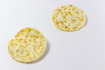 Crispy tempeh chips isolated white background. Indonesian snack. Tempeh crackers. Healthy food. Vegan. Traditional. Delicious.