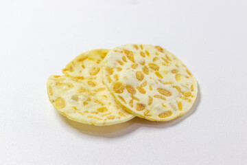 Crispy tempeh chips isolated white background. Indonesian snack. Tempeh crackers. Healthy food. Vegan. Traditional. Delicious.