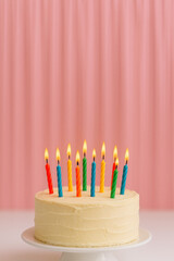 birthday cake with colorful candles on a festive background