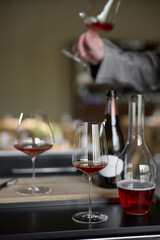Champagne tasting in restaurant, A man holds in his hand a beautiful elegant glass with rose sparkling wine