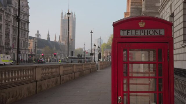 Classic red telephone booths line the charming streets of Westminster, highlighting Londons unique architecture and cultural heritage, making every visit memorable for tourists and locals alike