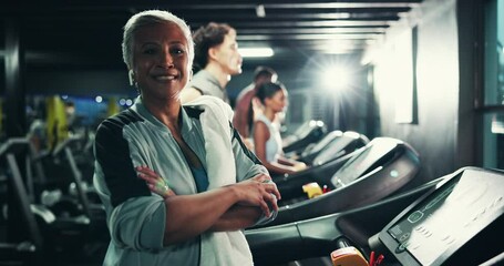 Mature, woman and face by treadmill in gym, towel and earphones with after workout confidence and pride. Cardio, laughing and audio tech for exercise, arms crossed and person at health club at night - Powered by Adobe