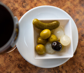 Black and green olives, onion, pickled cucumber - delicious snack