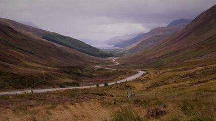 Small winding road through a valley in the Scottish Highlands