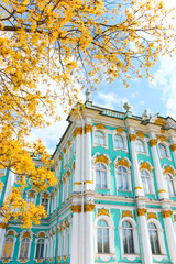 the incredibly picturesque facade of the Winter Palace through the branches of trees on a clear...