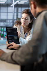 Team on engineers using tablet in data center, managing and optimizing IT infrastructure using...