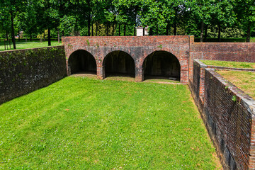 Beautiful view of well-preserved city walls of Lucca, stretching for over 4 kilometers. Walls are series of stone, brick and earthwork fortifications surrounding the center of Lucca. Tuscany, Italy.